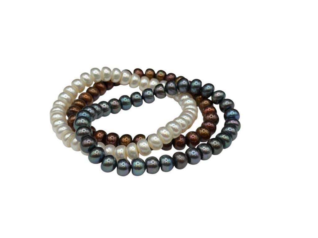 THREE DYED FRESHWATER PEARL BRACELETS: FEATURING BROWN, WHITE, AND PURPLE DYED PEARLS, ELASTIC BANDS 7MM PEARLS