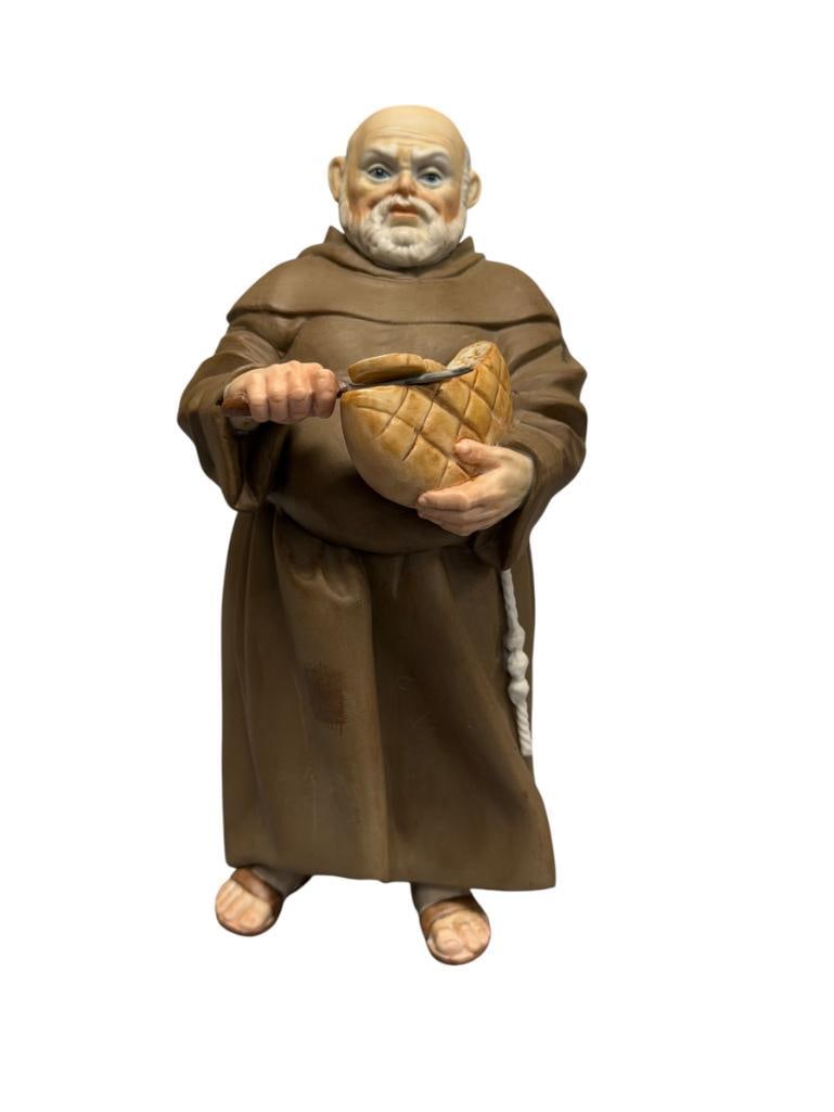 ALGORA PORCELAIN FIGURE OF A FRANCISCAN FRIAR CUTTING A LOAF OF BREAD MADE IN SPAIN: NO DAMAGE OR REPAIR 7 1/2" H