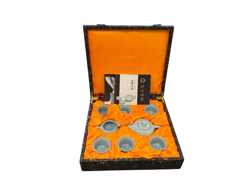 TING HUAI CHINESE PORCELAIN GOLDEN CROWN RU PERIWINKLE GLAZED TEA SET: EIGHT PIECE TEA SET WITH FAINT BLUE COLORED GLAZE WITH CRACKLED FINISH, INCLUDES EMBOSSED BLACK AND GOLD PRESENTATION BOX, ALSO INCLUDES BOOKLETS, IN LIKE-NEW CONDITION