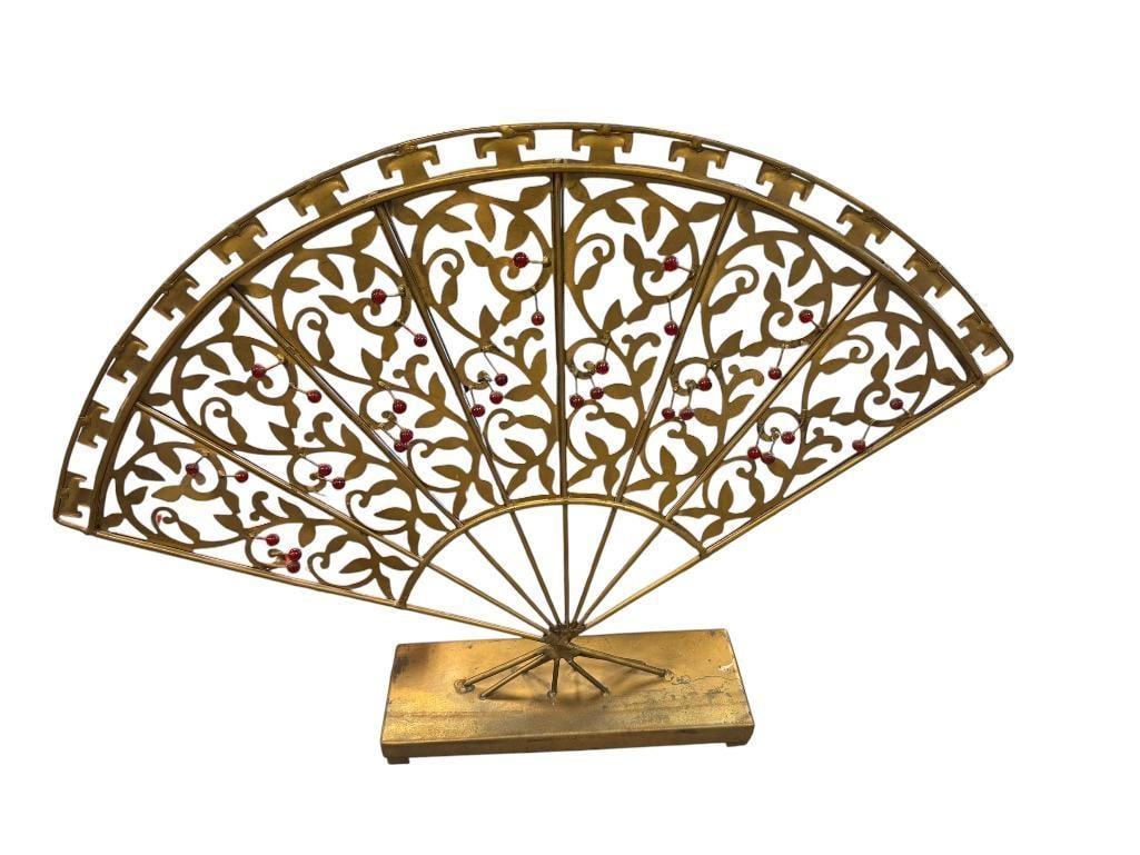 WORLD MARKET PIERCED METAL DECORATIVE FAN DECORATED WITH RED BEADS: PAINTED GOLD, MOUNTED ON SQUARE BASE 20" L, 13 1/2"