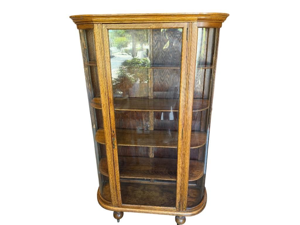 ANTIQUE QUARTER SAWN OAK CURIO / DISPLAY CABINET WITH CURVED GLASS SIDES: FIVE TIER WITH FOUR SHELVES WITH SLOTS FOR PLATES, BALL FEET WITH STEEL CASTORS, BACK OF CABINET IS NUMBERED 125/15, BACK BOARD DOES SHOW WEAR FROM AGE, ALL GLASS INTACT, NO LOCK KEY 41" X 14" X 65"
