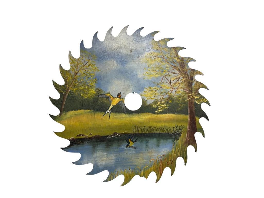 UNIQUE HAND PAINTED SAW BLADE BY ARTIST LADONNA ESTAL: DEPICTS BIRDS IN FLIGHT OVER A PONS WITH TREES AND GREENERY, SIGNED BY ARTIST IN LOWER RIGHT, ARTIST CARD ON BACK 12" DIAMETER