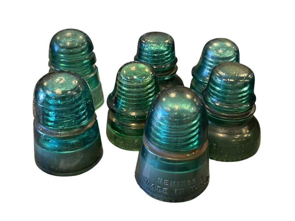VINTAGE GREEN GLASS HEMINGRAY AND STAR PHONE LINE INSULATORS: VINTAGE GREEN GLASS HEMINGRAY AND STAR PHONE LINE INSULATORS, SEVEN TOTAL 4" UP TO 4 1/4" H