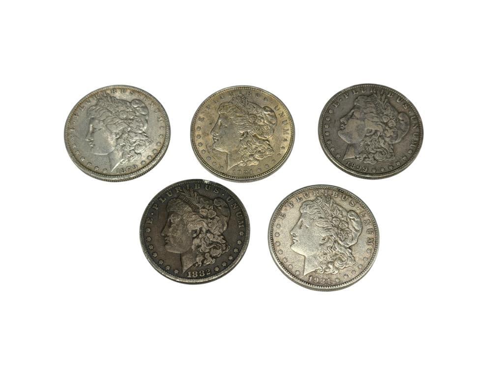 FIVE U.S. MORGAN SILVER DOLLARS: INCLUDING 1879-O, 1882, 1899-O, 1921, AND 1921-S, 90% SILVER