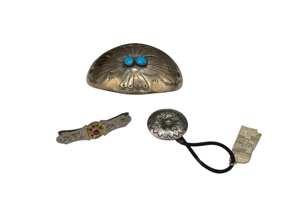 STERLING SILVER AND SILVERPLATED HAIR ACCESSORIES: INCLUDES STERLING SILVER CONCHO STYLE PIECE WITH TWO TURQUOISE, STERLING SILVER STAMPED HEART BUTTON, AND MONTANA SILVERSMITHS SILVERPLATED HAIR BARRETTE LARGEST PIECE IS 2 3/4", 17.82 GRAMS OF