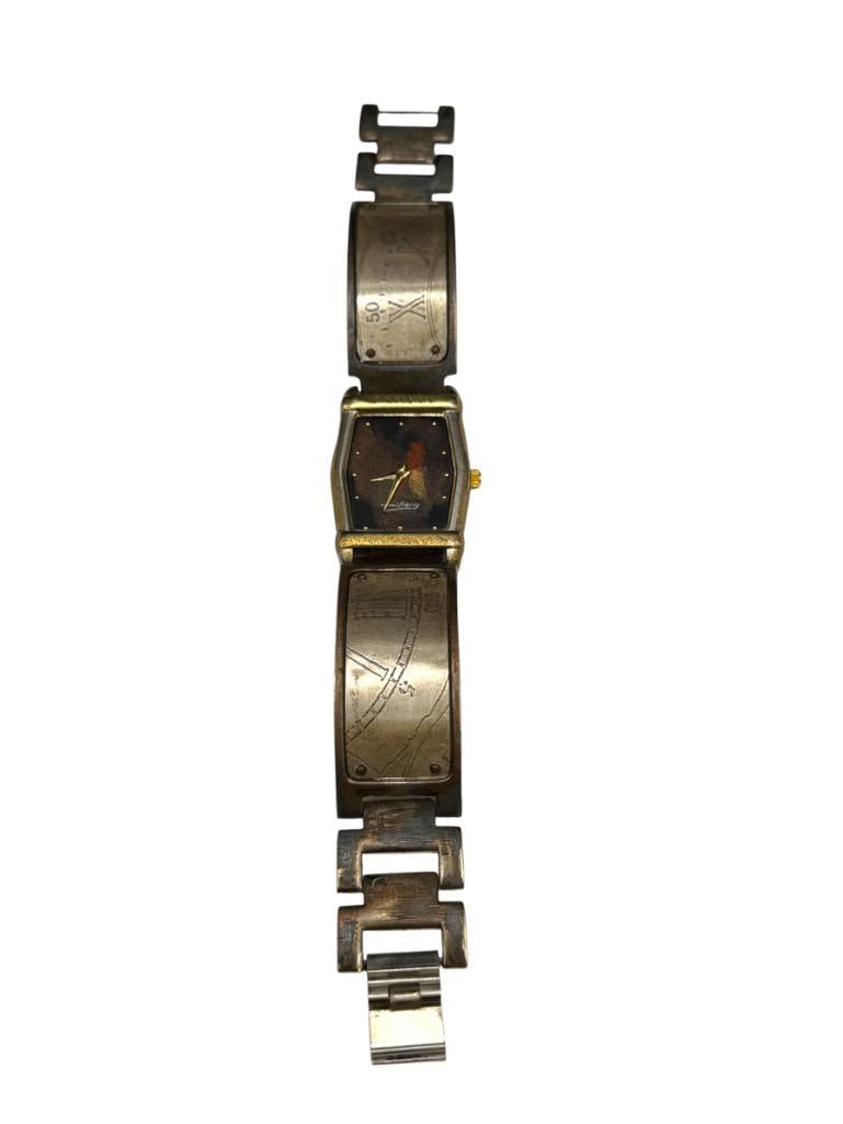 HANDCRAFTED WATCH CRAFT BY MILIERIS LIMITED EDITION LADIES WRISTWATCH: EDUARDO MILIERIS DESIGNER, QUARTZ MOVEMENT, NUMBERED 0368/1000, HAND DISTRESSED COPPER AND BRASS CASE, IN RUNNING CONDITION 26MM CASE 