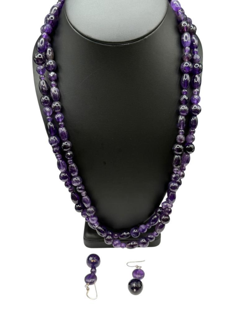 AMETHYST BEAD DOUBLE STRAND NECKLACE WITH STERLING SILVER CLASP AND MATCHING EARRINGS: EARRINGS HAVE STERLING HOOKS AS WELL, VARIOUS SHAPED AMETHYSTS BEADS INCLUDING SOME FACETED BEADS 23" NECKLACE, 2" EARRINGS, UP TO 14MM BEADS