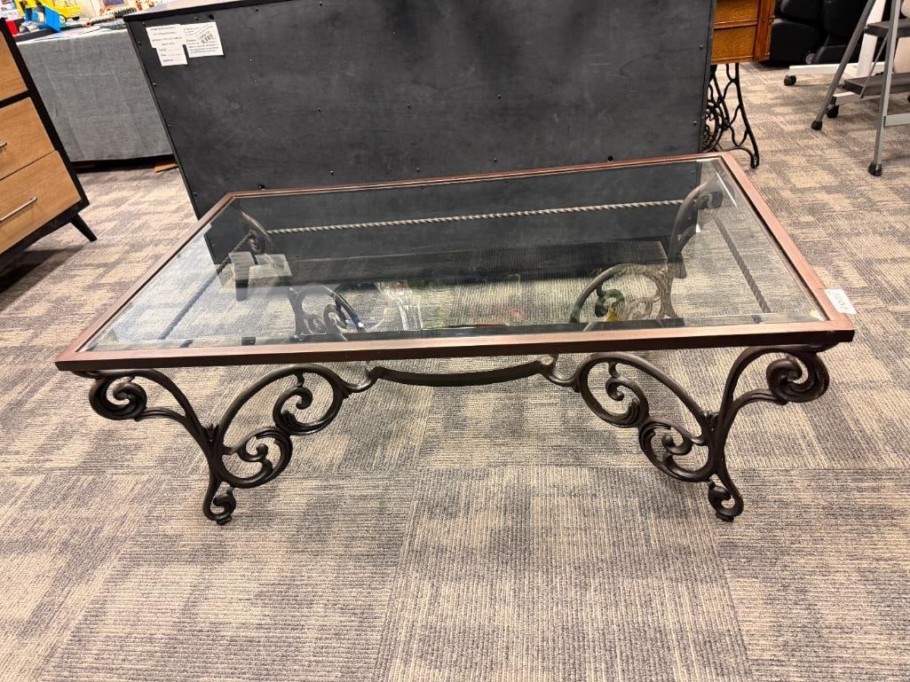 HEAVY METAL SCROLL DESIGN COFFEE / COCKTAIL TABLE IN BRONZE TONE WITH BEVELED GLASS TOP: FINISH DOES SHOW SOME LIGHT WEAR ALONG THE EDGES 50" X 30" X 19 1/2"