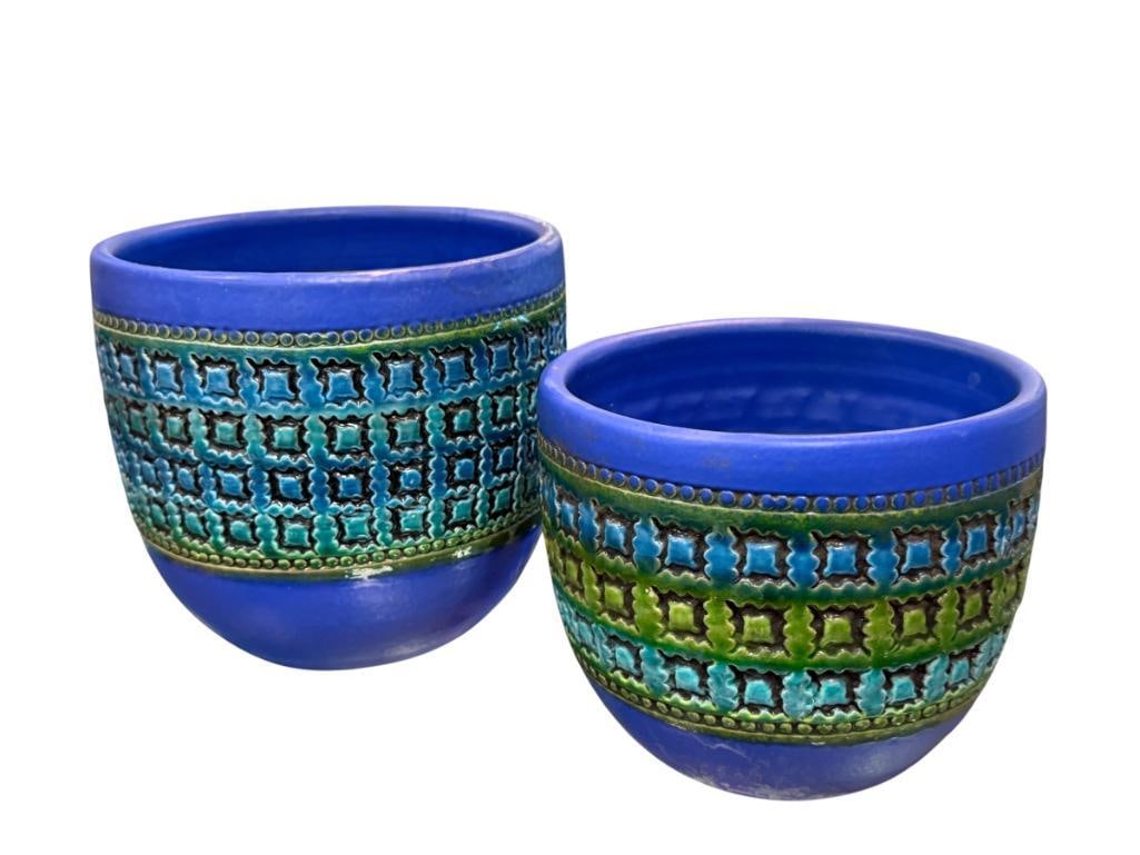 VINTAGE MID-CENTURY MODERN BITOSSI RIMINI BLUE PLANTERS DESIGNED BY ALDO LONDI: TWO BLUE GLAZE PLANTERS WITH BLUE AND GREEN GLAZE GEOMETRIC DESIGN BAND, MARKED ITALY ON THE BOTTOM, SOME WEAR FROM USE,NO MAJOR DAMAGE, LARGER PLANTER HAS HAS A MINOR REPAIR ALONG THE RIM 5" AND 6" H