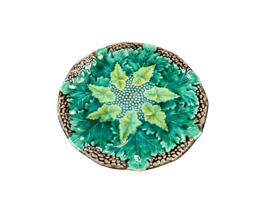 ANTIQUE VICTORIAN ERA EUROPEAN MAJOLICA PLATE NO. 181 RELIEF BOTANICAL PATTERN: GREEN AND YELLOW LEAVES, MOLD NUMBER ON THE BOTTOM, TWO SMALL CHIPS TO THE GLAZE ON THE EDGE 5 3/4" ROUND