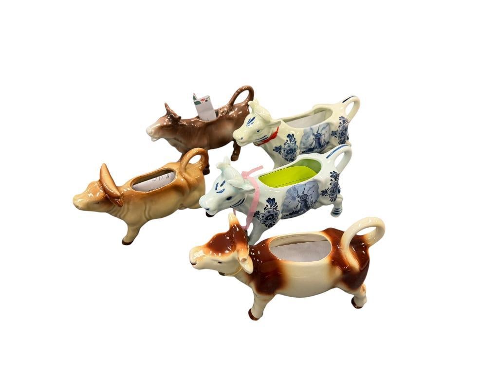 MID-CENTURY 1950'S - 1960'S COW FIGURL CREAMERS INCLUDING GOEBEL AND DELFT CREAMERS: TWO ARE MARKED ON THE BOTTOM, ONE HAS A "TINY" CHIP ON THE HORN TIP, OTHER HAS FLAW ON THE HOOVES 5 1/2" UP TO 7 1/4"" L