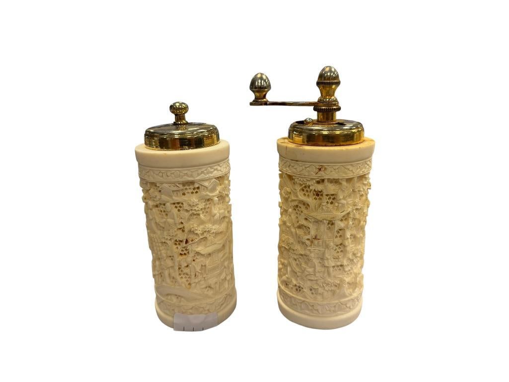 VINTAGE FAUX IVORY INTRICATELY CARVED RESIN CHINESE INSPIRED SALT SHAKER AND PEPPER GRINDER: BOTH ARE INTRICATELY CARVED WITH IMAGERY OF PEOPLE WITH FLORAL TRIM 4 1/2" H