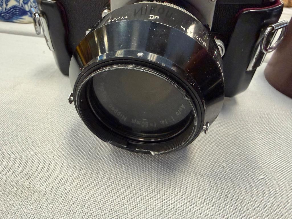 NIKON F 35MM SLR PROFESSIONAL FILM CAMERA INTRODUCED IN 1959 PLUS NIKKOR-H 28MM LENS NO. 631967 - 9