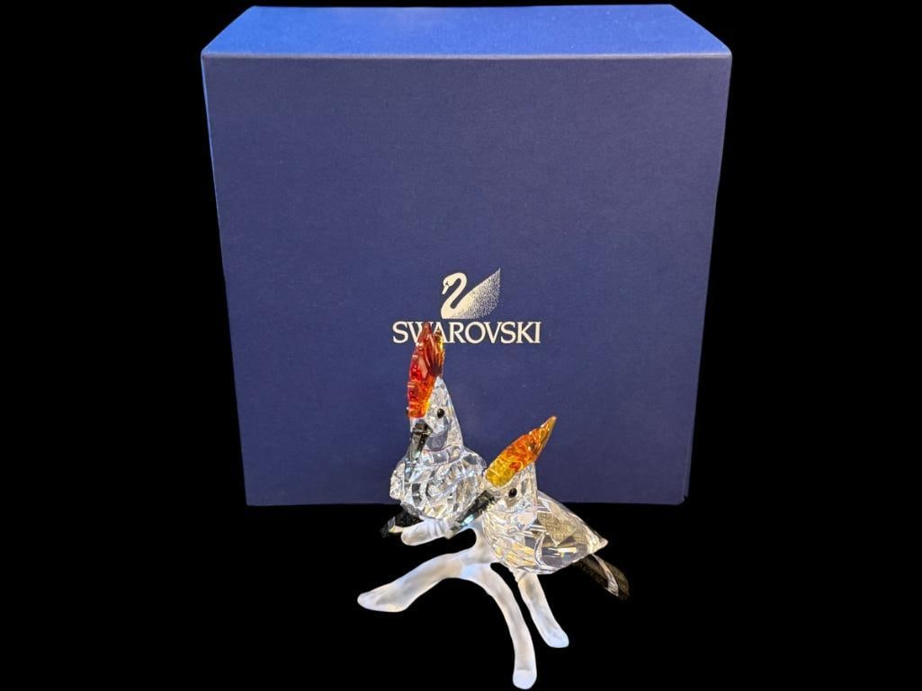 SWAROVKSI CRYSTAL HOOPES BIRD FIGURINES DESIGNED AND SIGNED BY ELISABETH ADAMER RELEASED IN 2008: FEATHERED BEAUTIES COLLECTION, FACETED CRYSTAL BIRDS ON A BRANCH WITH BLACK BEACKS AND TAIL FEATHERS AND TOPAZ CRESTS, IN MINT CONDITION WITH NO DAMAGE OR REPAIRS, INCLUDES THE ORIGINAL BOX, SIGN