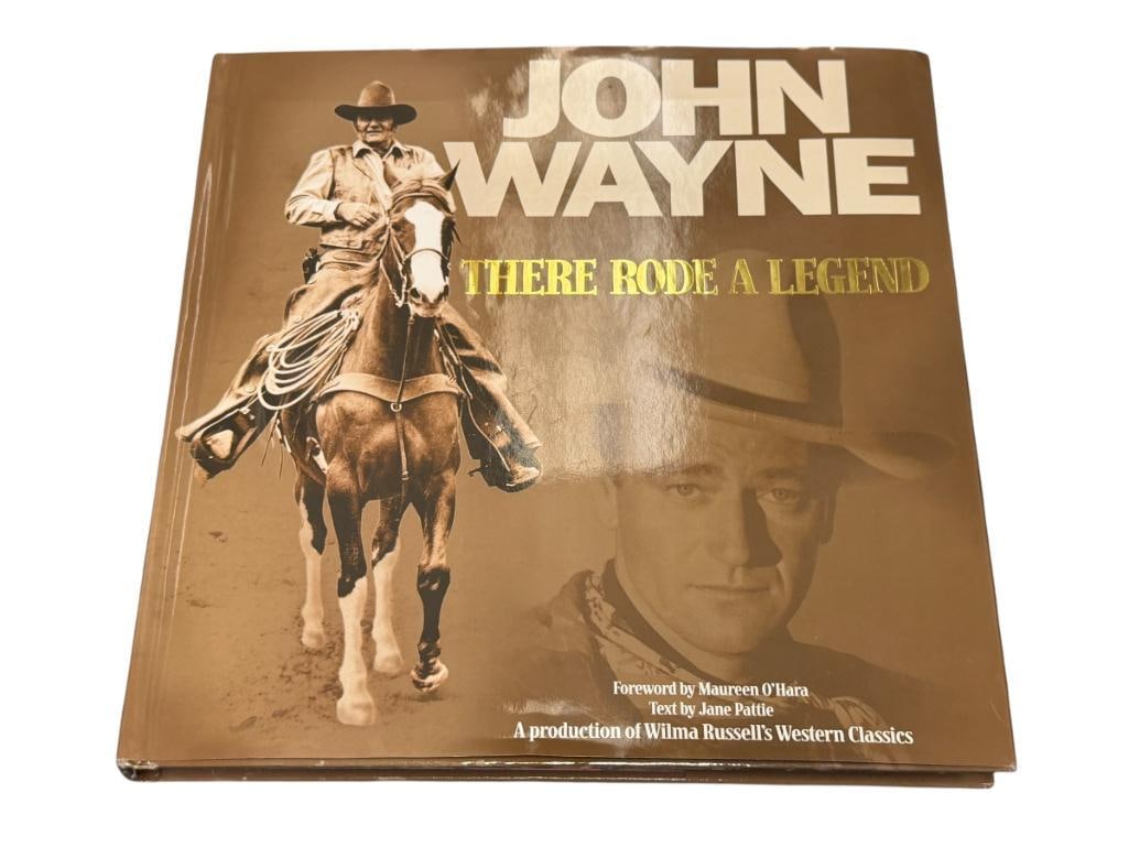 JOHN WAYNE THERE RODE A LEGEND WESTERN TRIBUTE BOOK: HARD BACK BOOK WITH DUST JACKET, FEATURES OVER 250 PAGES WITH FILMOLOGY OF THE AMERICAN ACTOR, IN GOOD CONDITION 11 3/4" X 11 3/4"