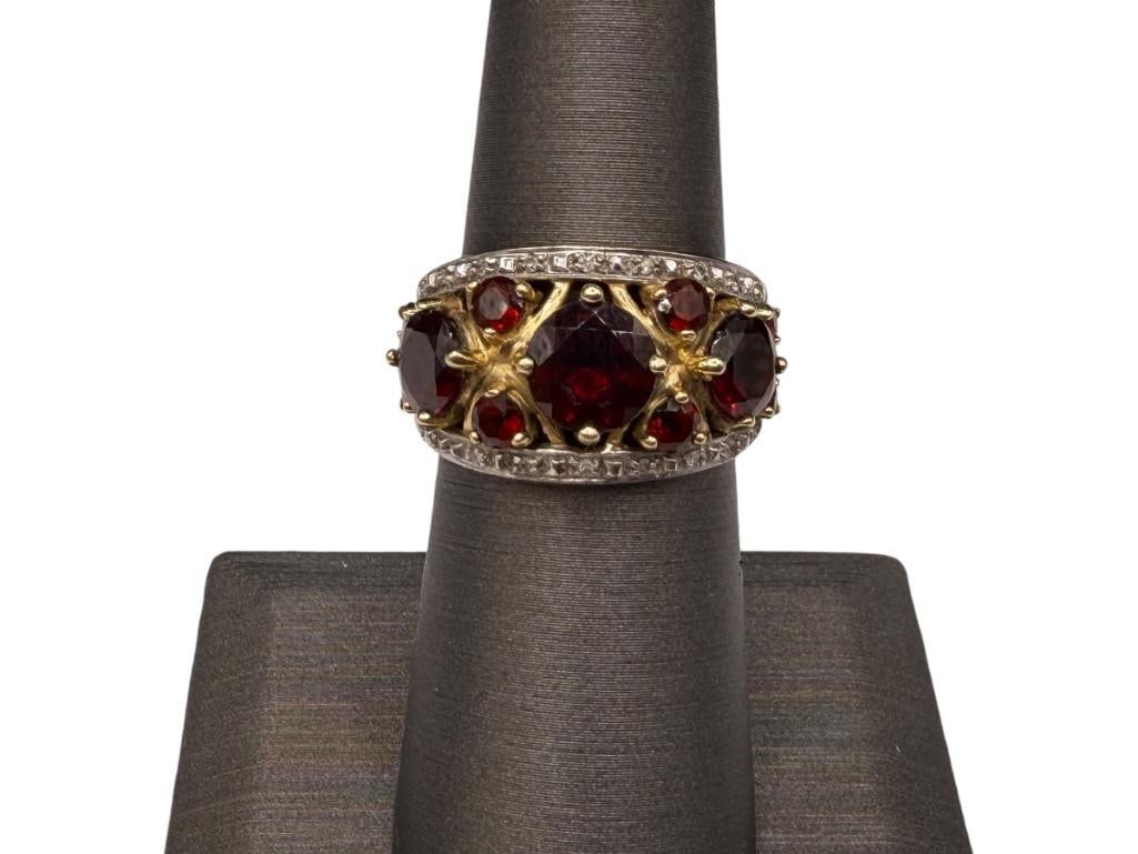 14K YELLOW GOLD GARNET AND DIAMOND FASHION RING: FEATURING ROUND CUT GARNETS AND ROUND CUT DIAMONDS INCLUDING THREE LARGE GARNETS AND EIGHT SMALLER GARNETS SIZE 6 1/4, 1/2" FRONT, 6.32 GRAMS, UP TO 7MM GARNETS, 1MM DIAMONDS