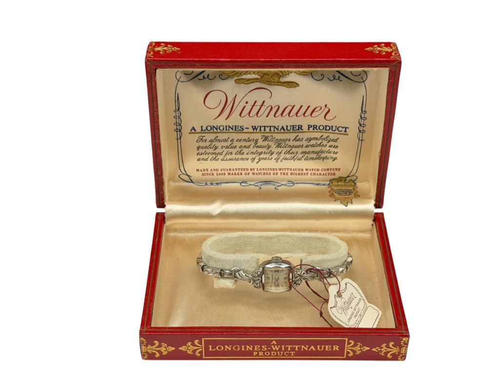 ANTIQUE LADIES 14K WHITE GOLD CASE WITTNAUER LONGINES 17 JEWELS WRISTWATCH: INCLUDES ORIGINAL BOX AND JEWELRY TAG, UNADJUSTED, SERIAL # 379004 409 ON CASE, CASE IS 14K WHITE GOLD AND HAS TWO ROUND CUT DIAMOND ACCENTS, BAND IS NOT GOLD, MOVEMENT AND WATCH IS IN GOOD CONDITION