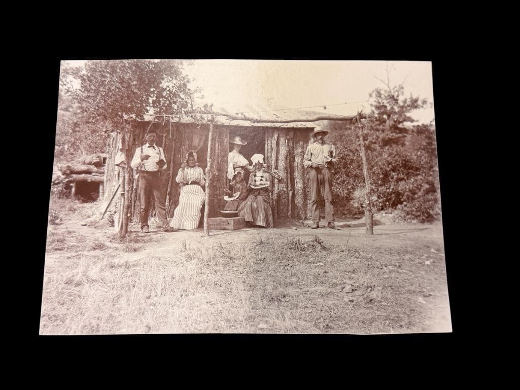 EARLY 20TH CENTURY PIONEER FAMILY SEPIA TONED ORIGINAL PHOTOGRAPH: DEPICTS EARLY PIONEER FAMILY POSING IN FRONT OF EARLY LOG HOME 6 1/2" X 4 3/4" 