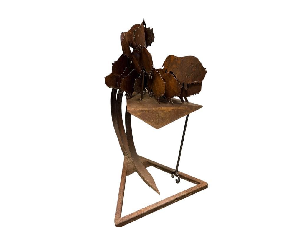LARGE RUSTIC METAL SCULPTURE OF BISON FIGURES ARRANGED IN A HERD WITH BASE / STAND: STAND IS CONSTRUCTED USING METAL PLATES MOUNTED ON TO CURVED PEDESTAL WITH TRIANGULAR BASE, HEAVY OVER 140 LBS APPROX. 55" X 39" X 60"
