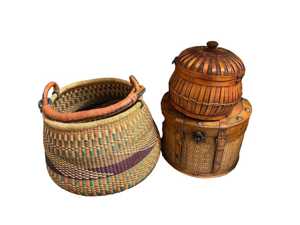 AFRICAN MARKET TRADE BASKET HAND WOVEN IN GHANA, WEST AFRICA AND TWO STORAGE BASKETS: WITH RUSTIC APPEAL, AFRICAN BASKET HAS ORIGINAL TAG AND HAS LEATHER WRAPPED HANDLE AFRICAN BASKET IS 15" X 12"
