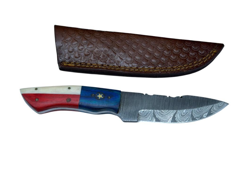 TEXAS THEMED BONE HANDLED DAMASCUS STEEL FIXED BLADE KNIFE: FEATURES BONE AND DYED RED AND BLUE WOOD HANDLE, FULL TANG BLADE WITH SERRATED BACK EDGE, INCLUDES LEATHER SHEATH 4 1/4" BLADE, 8" TOTAL LENGTH