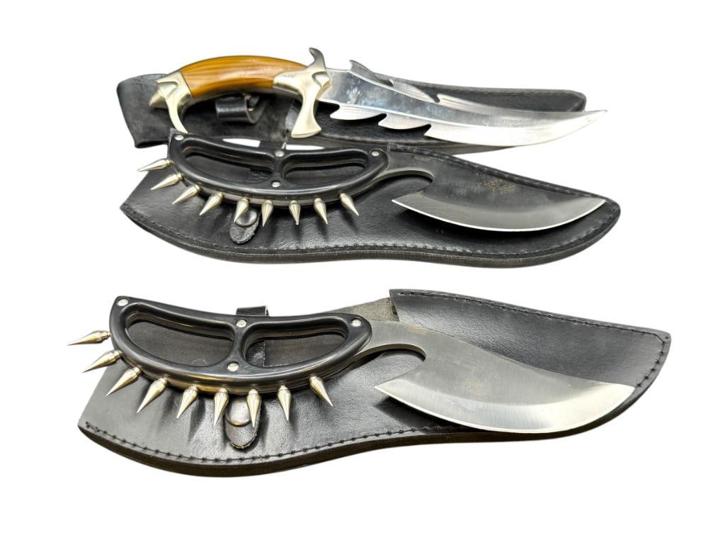 THREE STAINLESS STEEL FIXED BLADE KNIVES INCLUDING TWO WITH KNUCKLE BUSTER POINTS: ALL HAVE SYNTHETIC HANDLES, DRAGON INSIGNIA ON FANTASY DAGGER KNIFE, ALL HAVE BLACK FAUX LEATHER SHEATHS LARGEST HAS 7" BLADE AND 12" TOTAL LENGTH