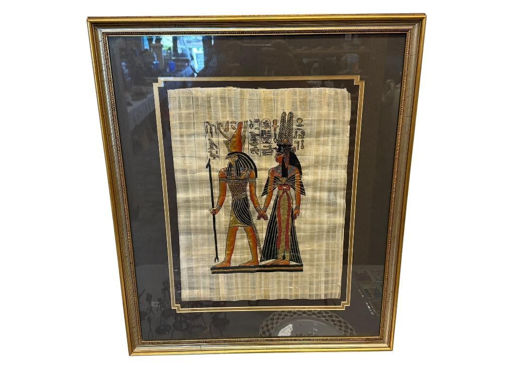 MODERN EGYPTIAN ORIGINAL PAINTING ON PAPYRUS PAPER OF GOD HORUS LEADING QUEEN NEFERTARI: DEPICTS EGYPTIAN GOD AND QUEEN HOLDING HANDS WITH HIEROGLYPHICS IN BACKGROUND, FRAMED 21 3/4" X 25 3/4" FRAME