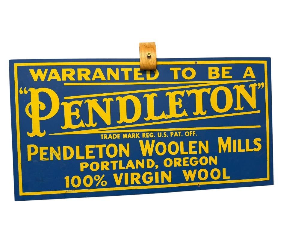 VINTAGE PENDLETON WOOLEN MILLS WOODEN ADVERTISEMENT SIGN: BLUE AND YELLOW SIGN READS WARRANTED TO BE A PENDLETON 100% VIRGIN WOOL, SHOWS MINIMAL WEAR / SCRATCHES, TWO HOLES DRILLED ON UPPER AND LOWER EDGE FOR HANGING 26 1/2" X 13 1/2" 