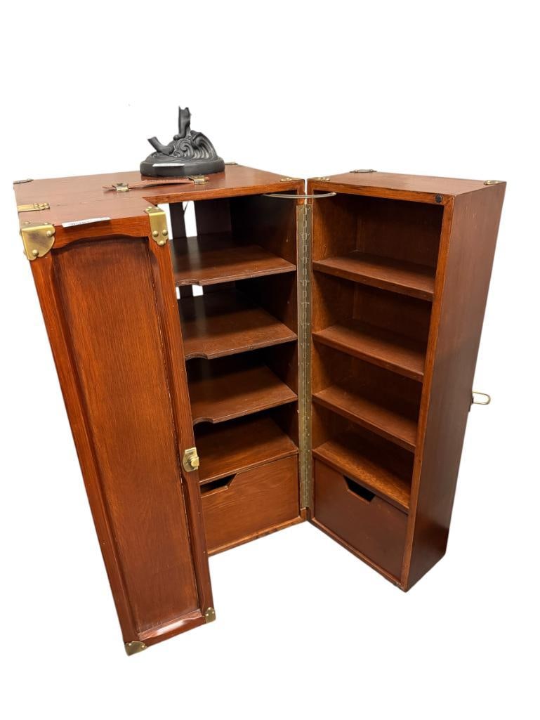 POTTERY BARN THURSTON TRUNK CABINET: TRUNK DESIGNED CABINET WITH HINGED SWING DOORS WITH WORKING LATCH, ADORNED WITH BRASS FINISH CORNER CAPS AND TOP LEATHER STRAP, TOP SHOWS LIGHT WEAR FROM SPILLS 21" X 22 1/2" X 38 1/2" 