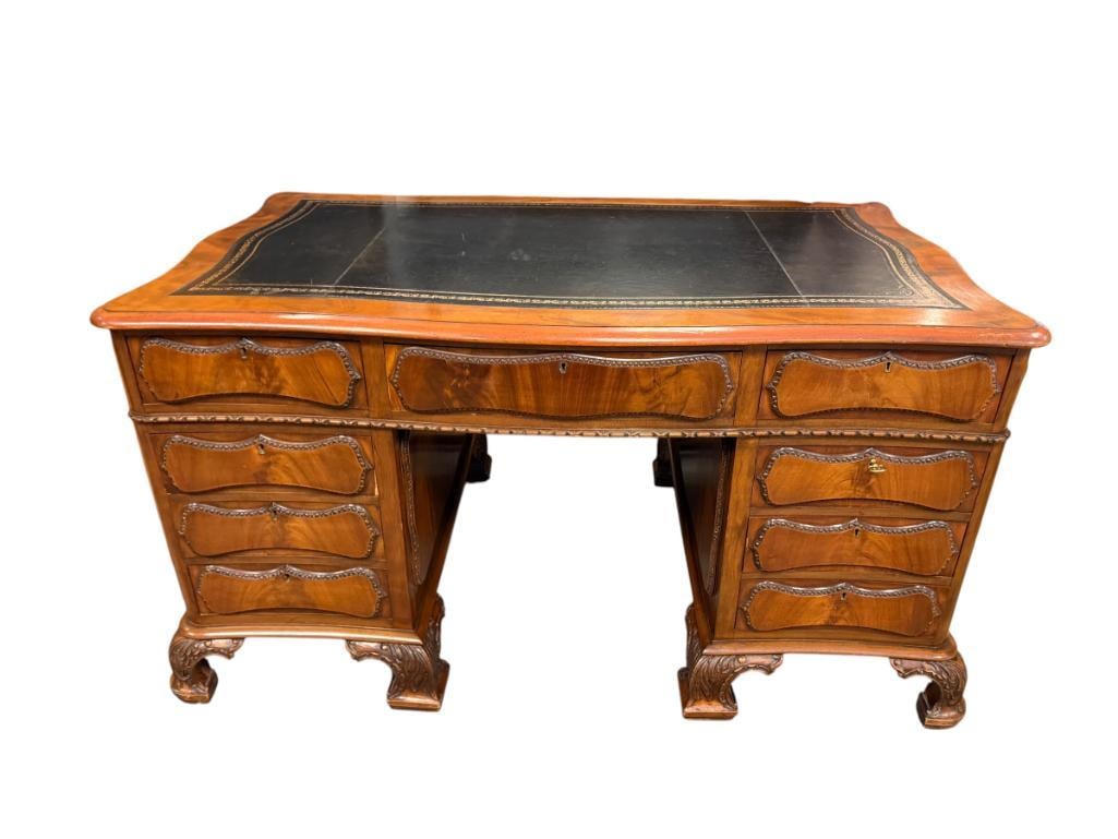 1930'S MAHOGANY EXECUTIVE DESK MADE BY S.P CHARTERIS CABINET MAKER MELBOURNE, VICTORIA, AUSTRALIA: RENOWNED CABINET MAKER ESTABLISHED IN 1880'S, ONE DRAWER IS DATED ON THE BOTTOM 1934, BEAUTIFUL DESK WITH BLACK LEATHER GILT EDGE EMBOSSED BORDER, CARVED TRIM, DECORATIVE CARVED LEGS, FEATURES NINE DR