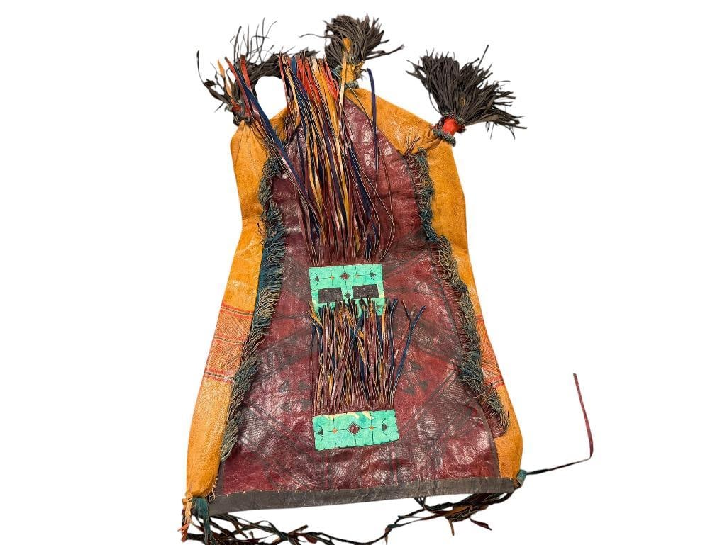 VINTAGE HAND CRAFTED TUAREG LEATHER BAG: DISTINCT HAND COLORED GEOMETRIC DESIGN, WITH THREE TASSLES ALONG THE BOTTOM, BRAIDED SHOULDER STRAP AND FRINGE 15" X 21"
