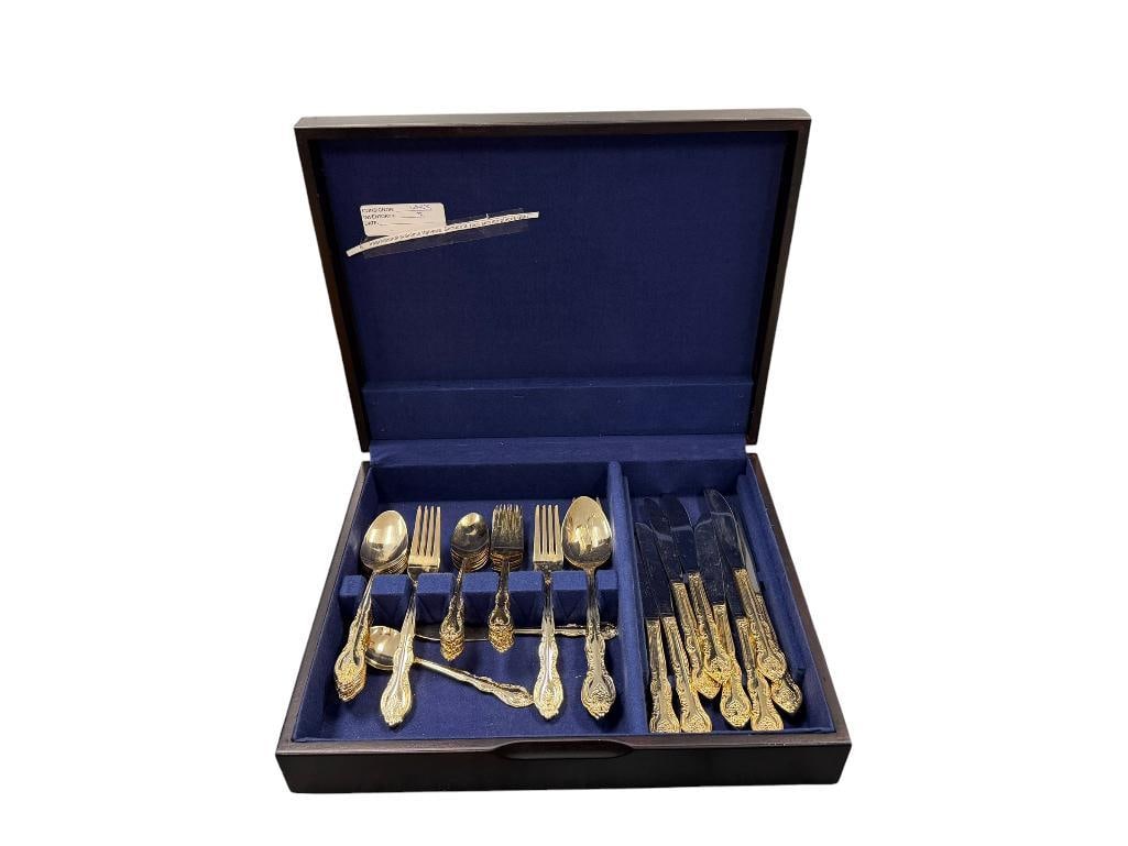 INTERNATIONAL STAINLESS STEEL GOLD PLATED FLATWARE SET: SIX PIECE SETTING FOR EIGHT, MISSING FOUR DINNER FORKS TO COMPLETE, INCLUDES SERVING PIECES AND DARK FINISH FLATWARE CHEST WITH TARNISH RESISTANT CLOTH