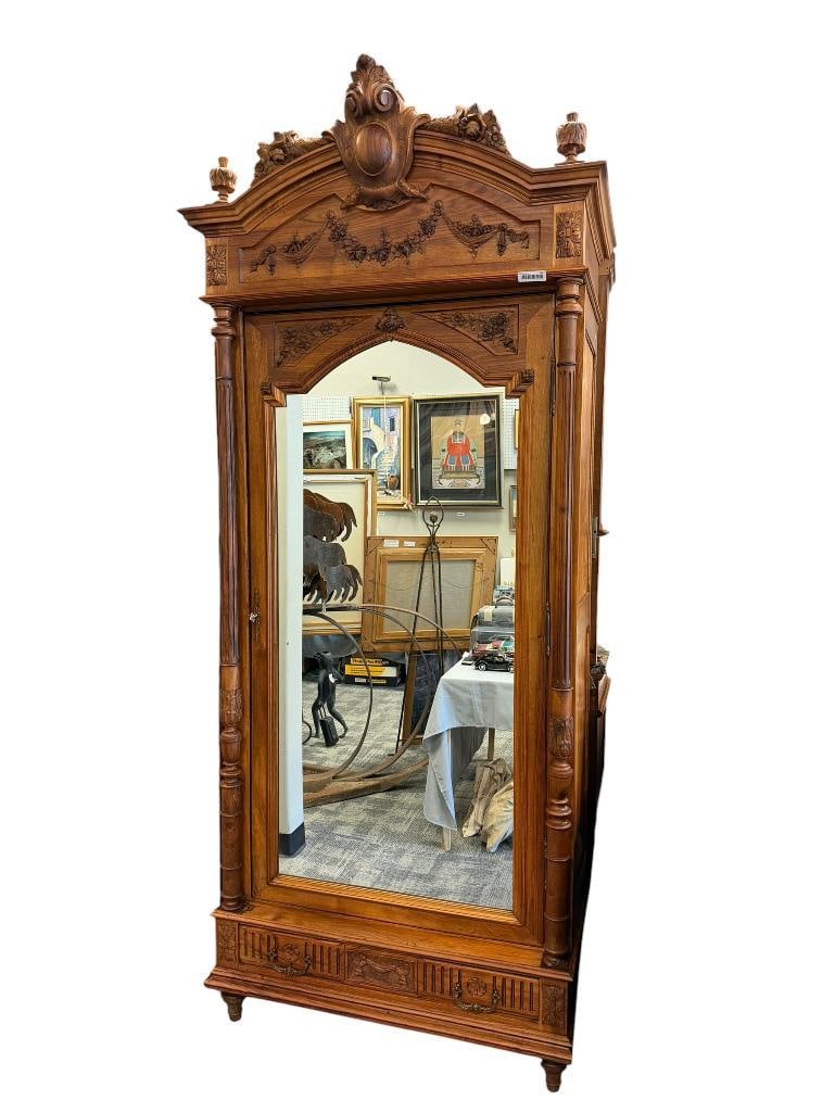 19TH CENTURY FRENCH ROCOCO ARMOIRE CRAFTED FROM WALNUT: FEATURES CARVED COLUMNS, URN AND RIBBON CARVED BOTTOM DRAWER, CARVED TOP FRONT DOOR, AND CARVED CROWN, INCLUDES ADJUSTABLE SHELVES WITH BRACKETS, OVERALL IN GOOD CONDITION WITH NO MAJOR REPAIRS OR