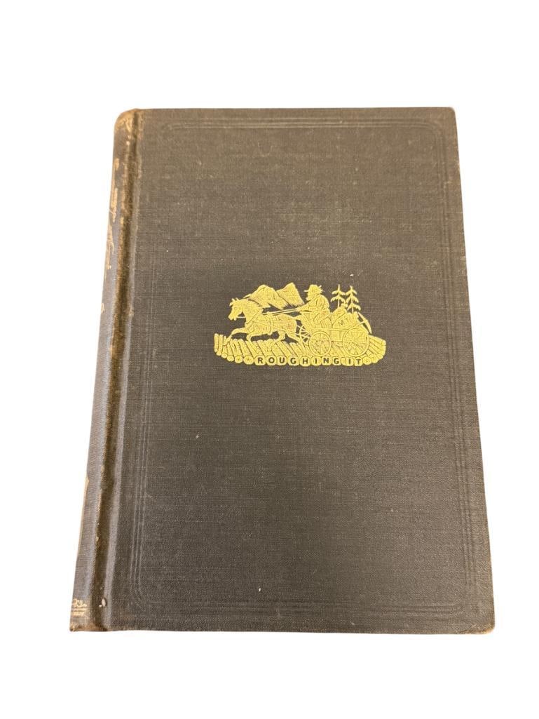 1892 ROUGHING IT BY MARK TWAIN BOOK ILLUSTRATED BY EMINENT ARTISTS PUBLISHED BY AMERICAN PUBLISHING: 592 PAGE BOOK WITH ILLUSTRATIONS, BLACK CLOTH COVERS WITH GILT ILLUSTRATED FRONT COVER AND LETTERING ON THE SPINE, OVERALL IN GOOD CONDITION WITH WEAR / AGE SHOWN 6 1/2" X 9"