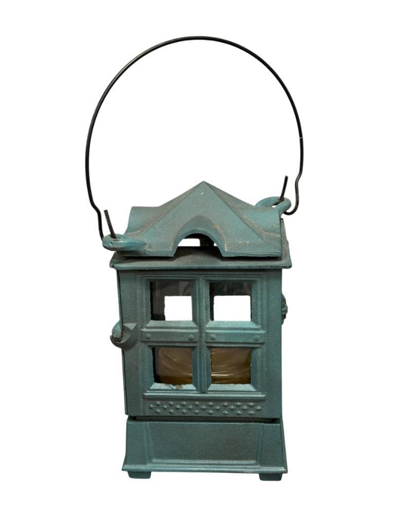 1988 JOHN WRIGHT GARDEN / TREE LANTERN GREEN PATINA FINISH: SQUARE LANTERN WITH ACRYLIC WINDOWS AND GLASS BURNER, MARKED ON THE BOTTOM, FEATURES WIRE HANDLE 9" H