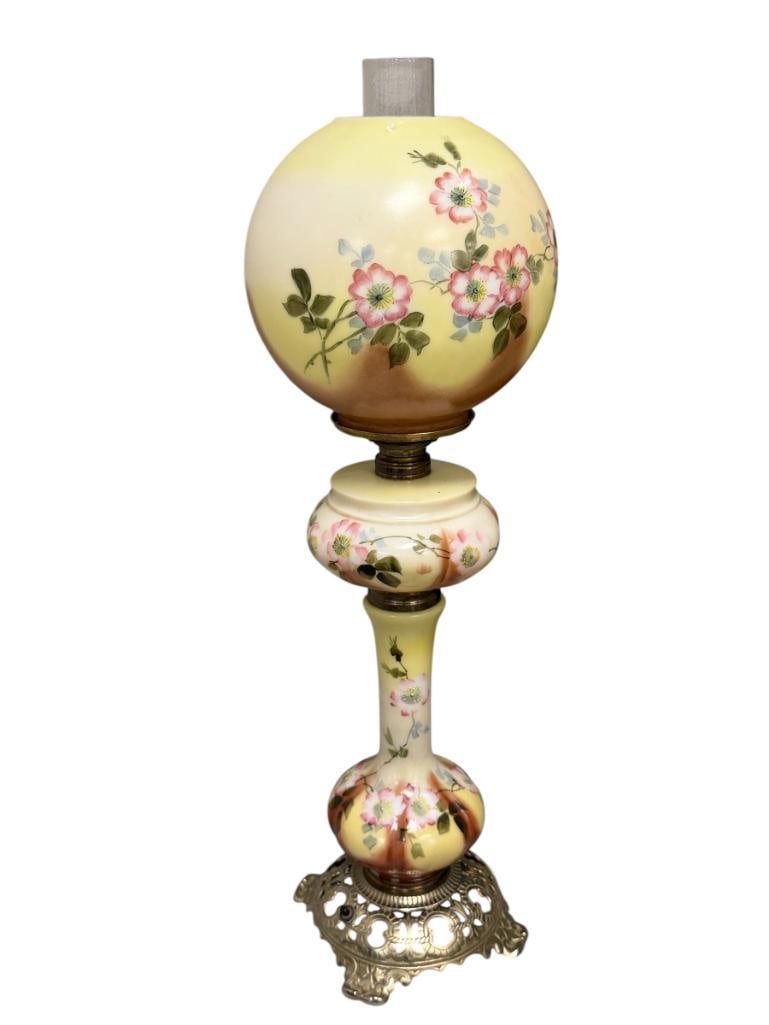 ANTIQUE THREE TIER HAND PAINTED PORCELAIN BANQUET TABLE LAMP FLORAL DESIGN: LAMP FEATURES ORNATE BRASS BASE WITH HAND PAINTED COLUMN, FONT, AND MATCHING SHADE, INCLIUDES CHIMNEY, TESTED + 28" H