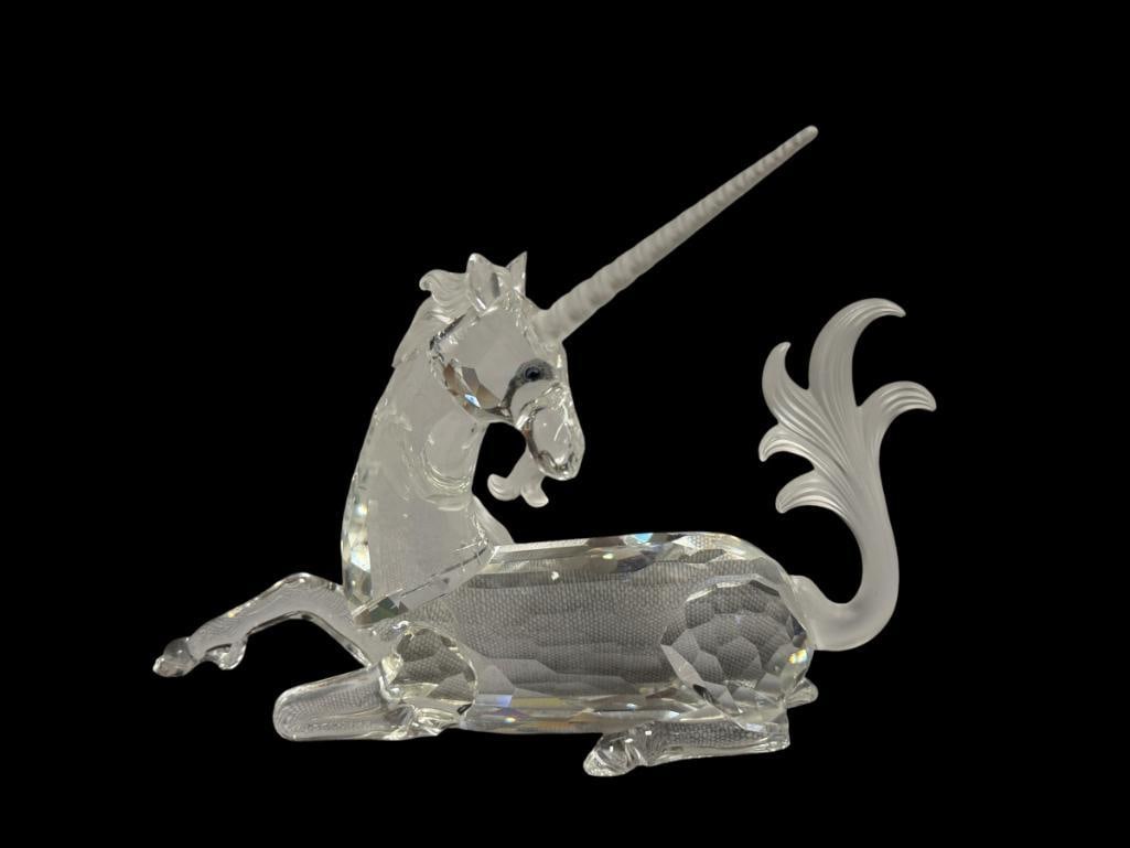 SWAROVSKI CRYSTAL SCS ANNUAL EDITION THE UNICORN NO. 191727 FABULOUS CREATURES 1996: DESIGNED BY MARTIN ZENDRON, FEATURES A FROSTED MANE, BEARD AND TAIL, LASER ETCHED WITH HALLMARK AND DESIGNER INITIALS, ONE EAR HAS A CHIP, INCLUDES ORIGINAL BOX 5 5/8" L