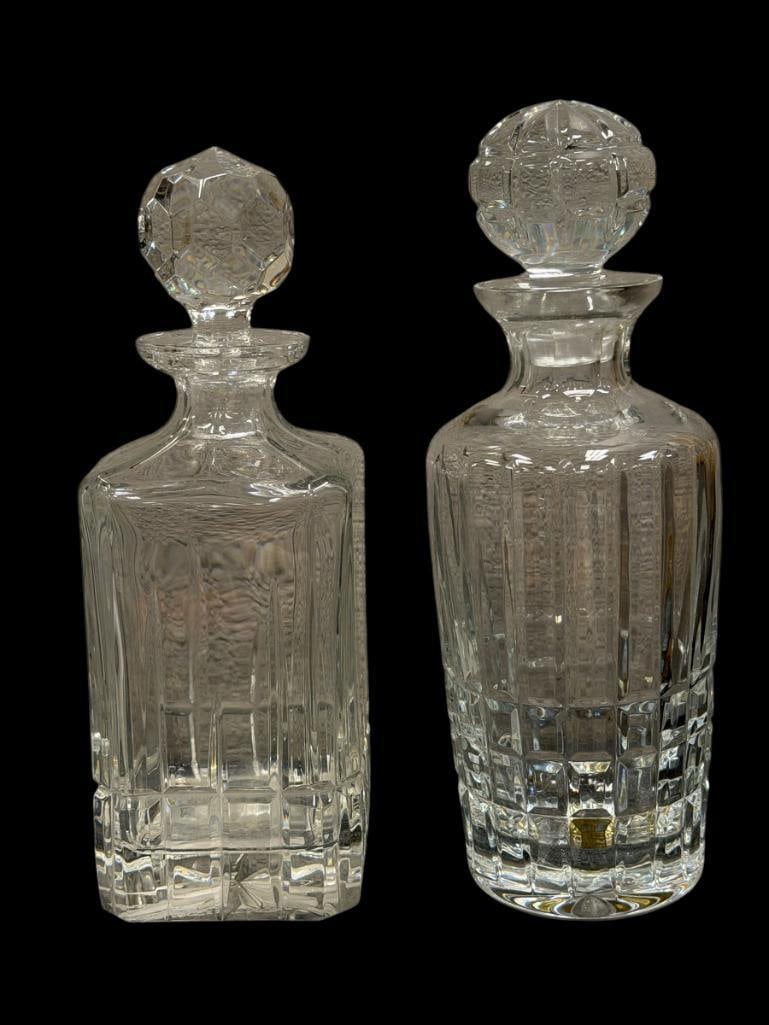 TWO CRYSTAL DECANTERS WITH STOPPERS: BOTH DECANTERS HAVE MATCHING STOPPERS, FACETED STOPPER HAS A TINY CHIP 10 1/8" AND 10 1/2" H