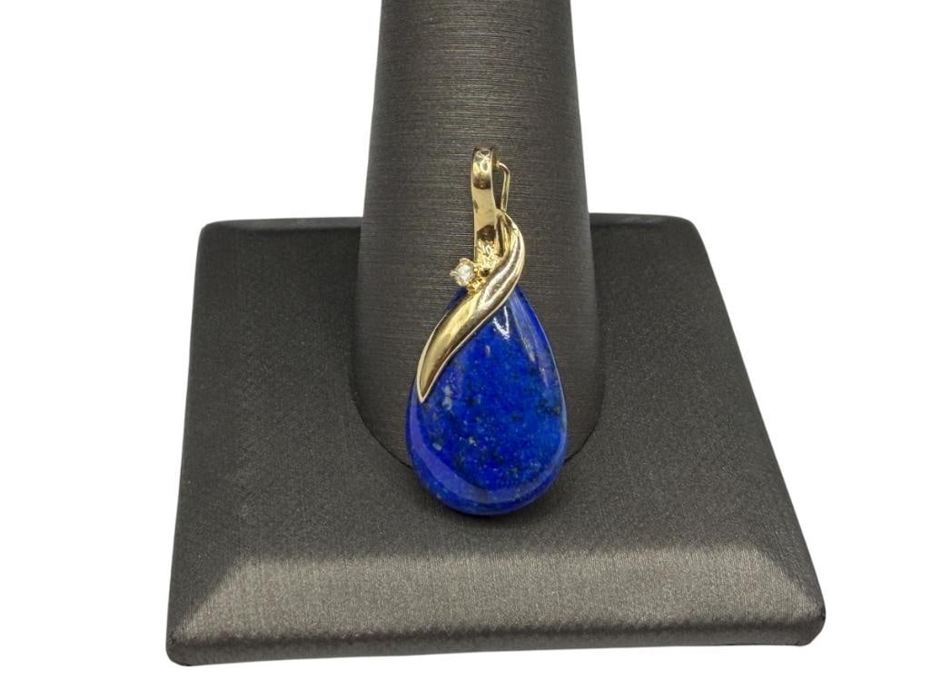 14K YELLOW GOLD LAPIS AND DIAMOND FASHION PENDANT: FEATURING A POLISHED TEAR DROP LAPIS ACCENTED BY SINGLE ROUND BRILLIANT CUT DIAMOND ON BAIL 1 1/8", 1MM DIAMOND, 2.18 GRAMS