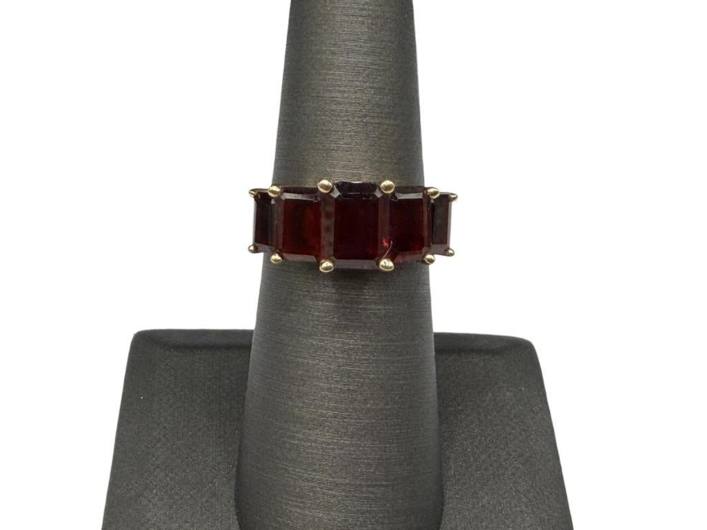 14K YELLOW GOLD EMERALD CUT GARNET FASHION RING FEATURING TAPERED DESIGN AND GRADUATED GARNETS: FEATURING FIVE EMERALD CUT GARNETS, MARKED "P14K" FOR 14K PLUMB SIZE 6, 5/16" FRONT, APPROX. 5.00CTTW GARNETS, 3.83 GRAMS
