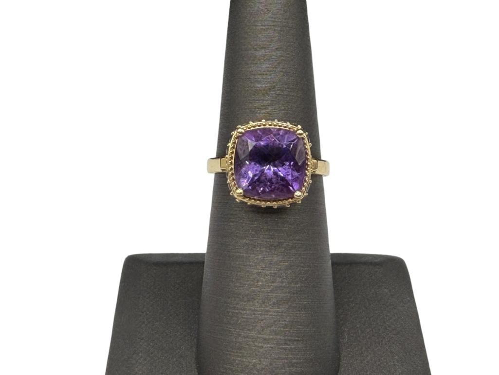 14K YELLOW GOLD CUSHION CUT AMETHYST AND ROUND CUT TANZANITE FASHION RING: DESIGNER HALLMARKED, CUSHION CUT AMETHYST IS ACCENTED BY APPROX. 50 ROUND CUT TANZANITES SIZE 6 1/4, 1/2" FRONT, 4.00CT AMETHYST, .25CTTW TANZANITES, 4.09 GRAMS