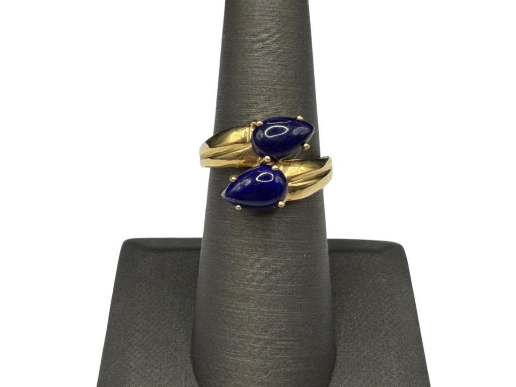 14K YELLOW GOLD PEAR CUT CABOCHON BLUE LAPIS BYPASS RING: FEATURING TWO PEAR CUT CABOCHON BLUE LAPIS AND RIBBED DESIGN ON SHOULDERS OF SHANK SIZE 6 1/4, 5/8" FRONT, 3.35 GRAMS, 9MM X 6MM LAPIS