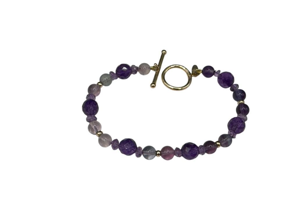 ZOE B. DESIGNER SIGNED ROUND AND FACETED AMETHYST BEAD BRACELET WITH 14K YELLOW GOLD TOGGLE CLASP: SIGNED ON CLASP 7 1/2", UP TO 8MM BEADS