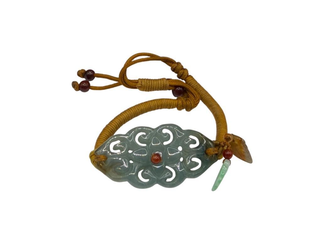 ARTISAN CARVED GREEN JADE WITH ROPE STRAND BRACELET: JADE IS 1 3/4", ADJUSTABLE LENGTH
