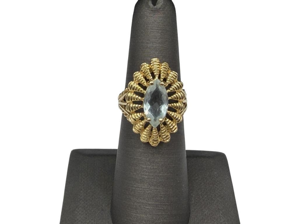 14K YELLOW GOLD MARQUISE CUT AQUAMARINE FASHION RING: FEATURING ELABORATE GOLD DESIGN AROUND AQUAMARINE, HALLMARKED BY MAKER SIZE 6 1/2, 1" FRONT, 4.23 GRAMS, 1.50CT AQUAMARINE