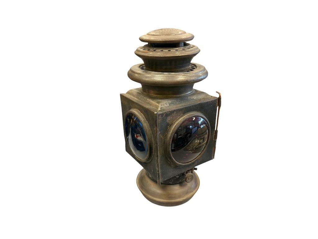 CIRCA 1910 FORD MODEL 115 REAR / SIDE KEROSENE LAMP MADE BY THE JNO. W. BROWNING MFG. CO.: LAMP FEATURES BLUE, RED, AND CLEAR GLASS SHADES, INTACT NO CRACKS, EMBOSSED LETTERING ON THE TOP, OBVIOUS WEAR SHOWN FROM AGE AND USE, OVERALL IN GOOD CONDITION 10 3/4" H