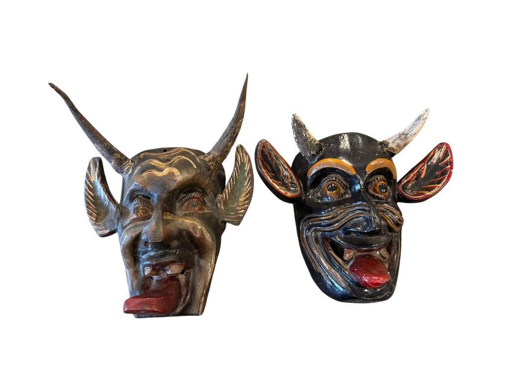 HAND CARVED WOOD MEXICAN FOLK ART DIABLO / DEVIL MASKS POSSIBLY FROM OAXACA, MX: HAND CARVED MASKS MADE WITH REAL ANIMAL HORNS, BOTH ARE HAND PAINTED WITH LARGE EARS AND PROTRUDING TONGUES, GLOSSY FINISH MASK HAS HAD TONGUE PREVIOUSLY REPAIRED 8 1/2" AND 11"