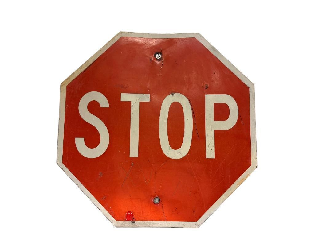 VINTAGE RED AND WHITE OCTAGONAL METAL STOP SIGN: HAS HOLES FROM BEING MOUNTED 24" X 24"