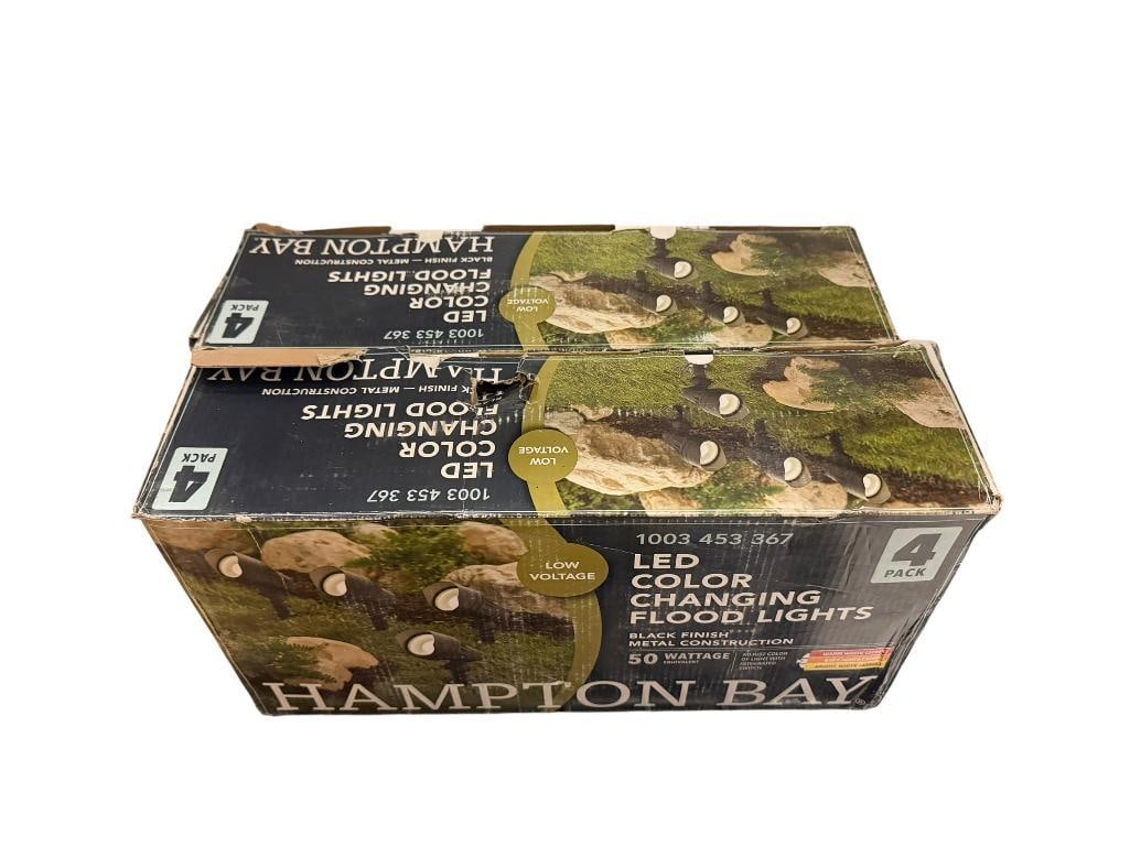 TWO NEW IN BOX SETS OF HAMPTON BAY LED COLOR CHANGING FLOOD LIGHTS: EACH BOX CONTAINS FOUR LIGHTS, BLACK FINISH METAL CONSTRUCTION, 50 WATT, NOT SOLAR, MUST BE PLUGGED IN