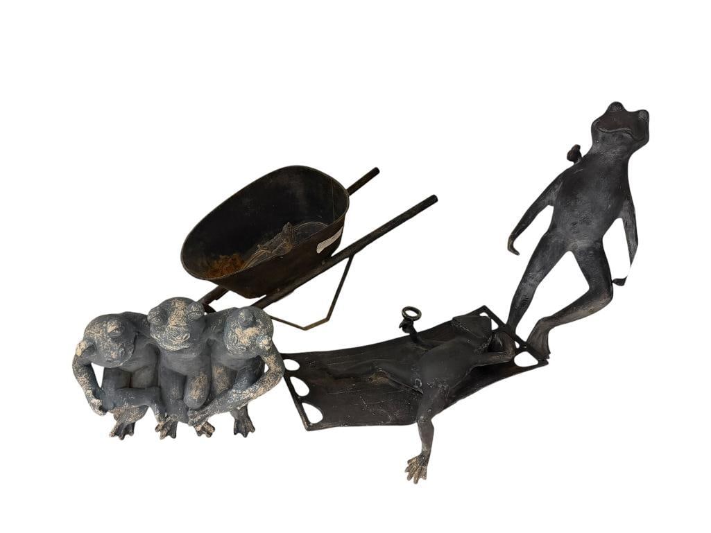 CAST ALLUMINUM FIGURAL YARD ART FROG SCULPTURES INCLUDING SPI " FROG FRIENDS ": FOUR PIECES INCLUDING WHEEL BARROW, LOUNGING FROG, STANDING FROG, AND THREE FROGS ON A BENCH RESIN SCULPTURE, ALL SHOW WEAR FROM BEING OUTDOORS LARGEST IS 19" H